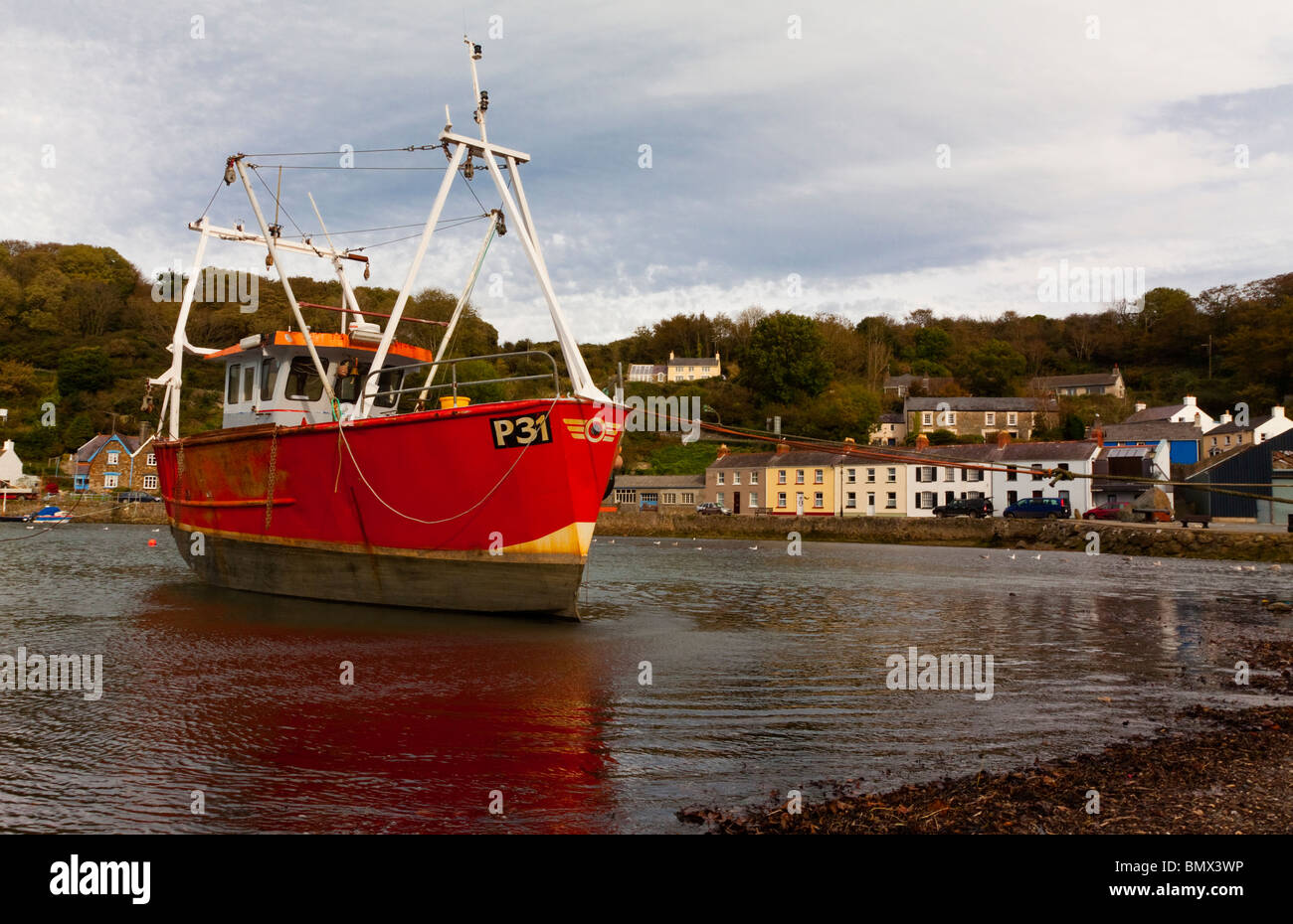 Fishing boat moored in the harbour at Lower Fishguard in Pembrokeshire South Wales Stock Photo