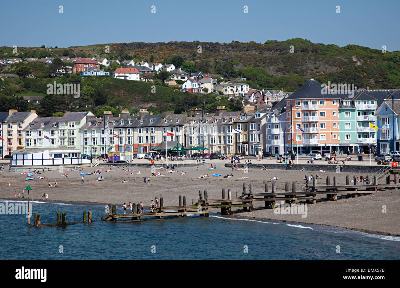 Beach and jetty with sea front hotels Aberystwyth Wales UK Stock Photo