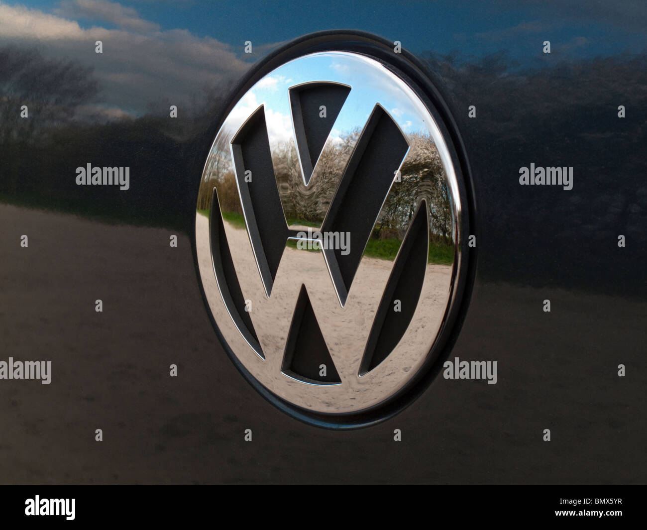 Close up view of a chrome Volkswagen VW logo on a car with reflections Stock Photo