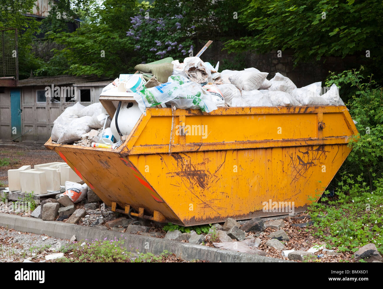 Skip filled with rubbish waiting for disposal England UK Stock Photo