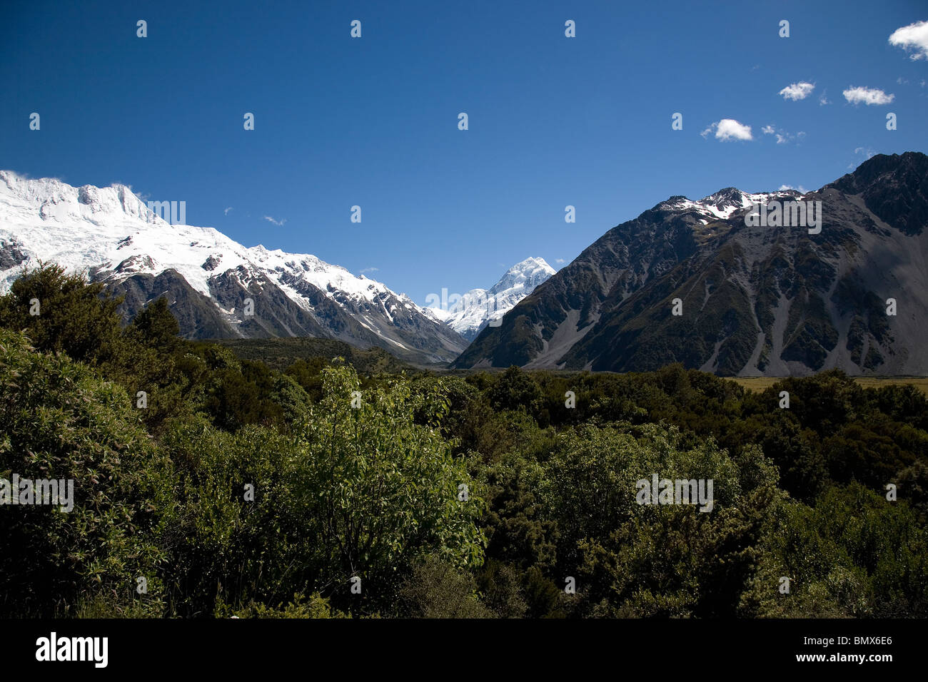 A snow capped Mount Cook peak through the valley Stock Photo