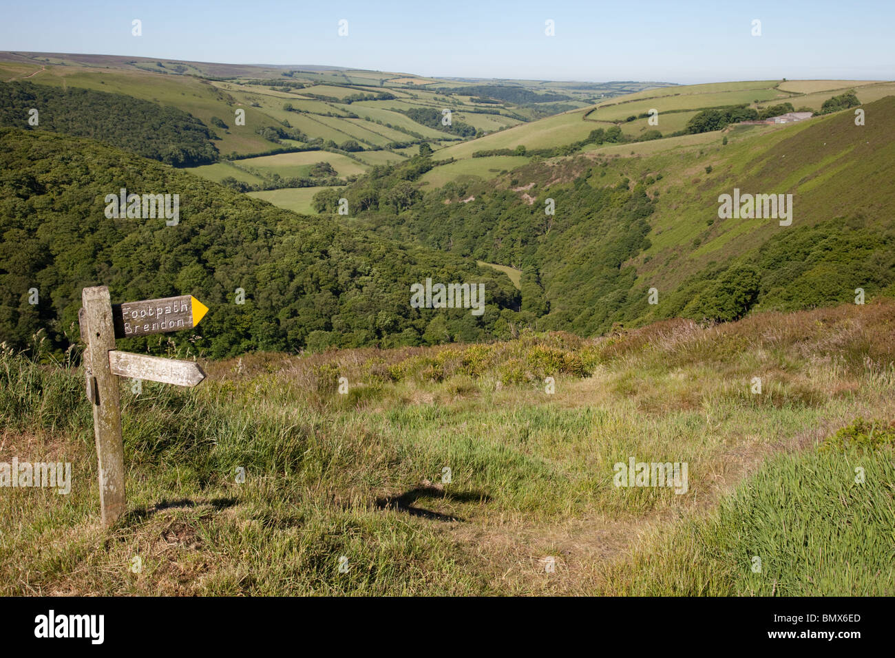 Signpost above wooded valley on Exmoor taken from Countrygate Country Park near Porlock Somerset UK Stock Photo