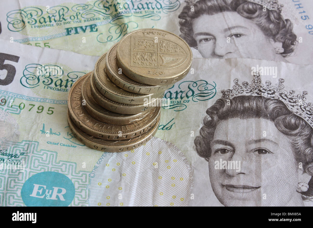 A stash of used, dirty English money consisting of coins and notes Stock Photo