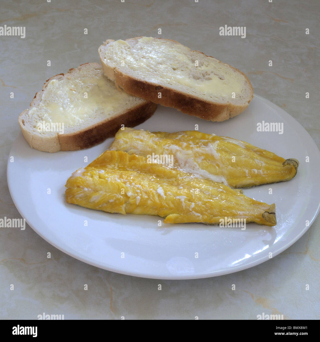 Smoked Haddock Fillets and Buttered White Crusty Bread on a Dinner