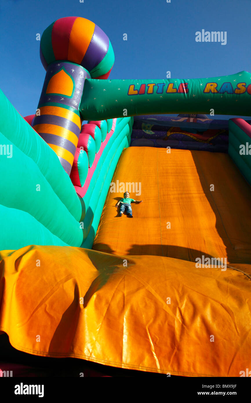 Inflatable slide boy sliding down fun hi-res stock photography and ...