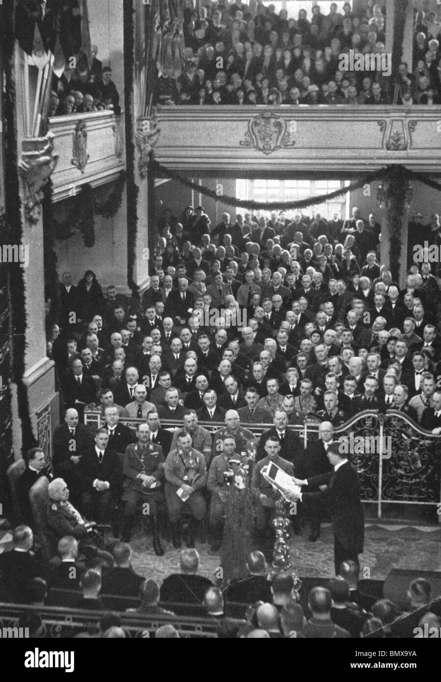 PAUL von HINDENBURG seated left watches as Adolf Hitler as Chancellor reads an address in Potsdam Garrison church 21 March 1933 Stock Photo