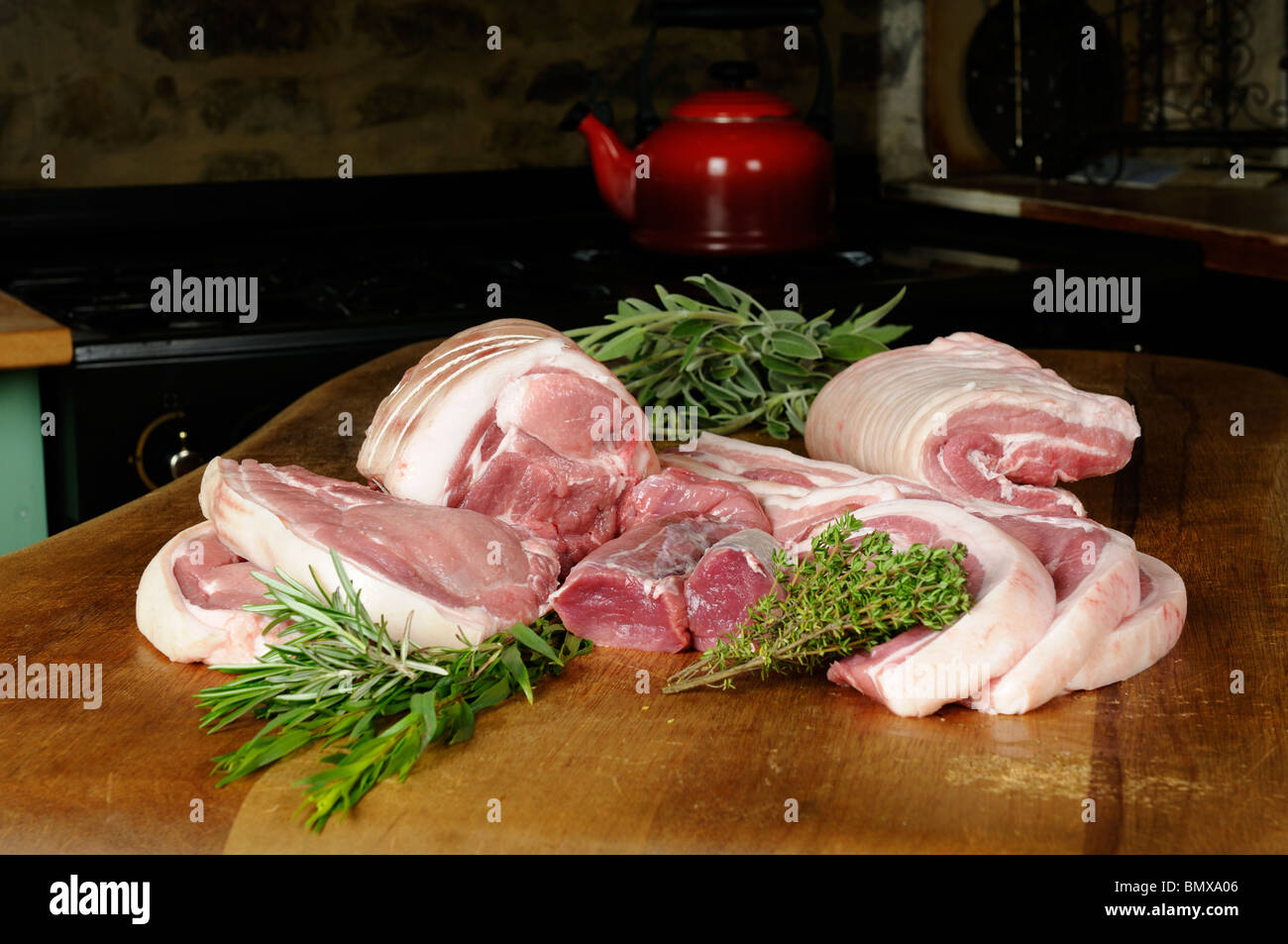 Stock photo of a selection of raw pork products on a wooden kitchen table. Stock Photo
