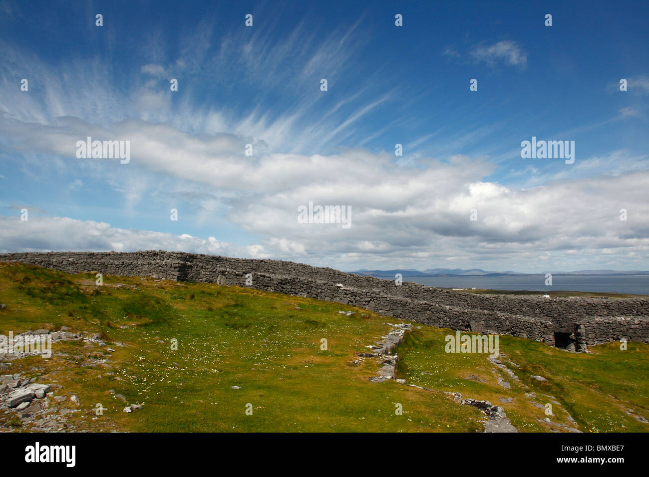 Dramatic skies over Dun Aengus fort looking to Connemara from Aranmore,inishmore,Aran isles,Co Galway,western Ireland,Eire. Stock Photo