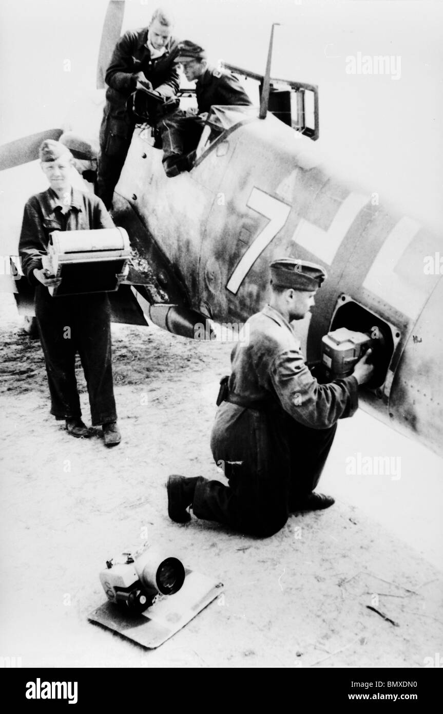 Dinard, St.Malo - France Luftwaffe Technician Slides the Camera into a Messerschmitt 109 Converted for Reconnaissance Purpose. Stock Photo