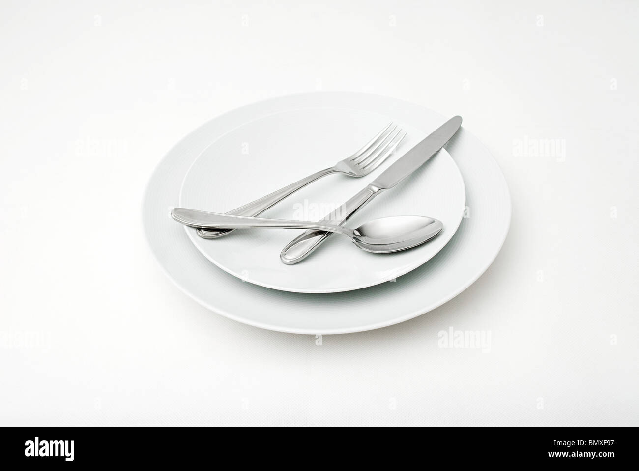 Cutlery on plates Stock Photo Alamy
