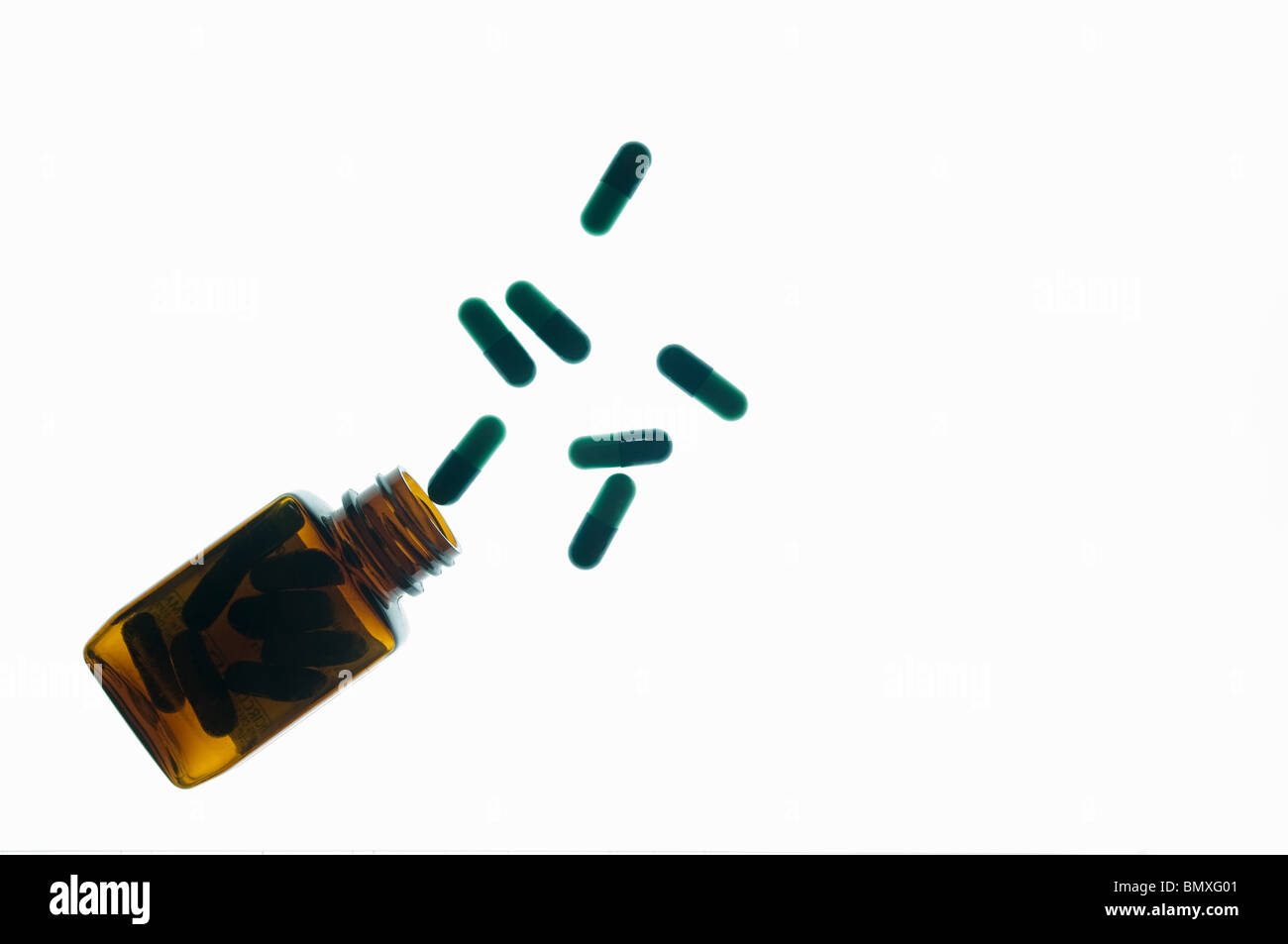 Medicine bottle and capsules Stock Photo