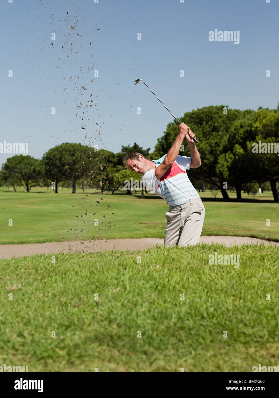 Man playing golf, stuck in bunker Stock Photo Alamy