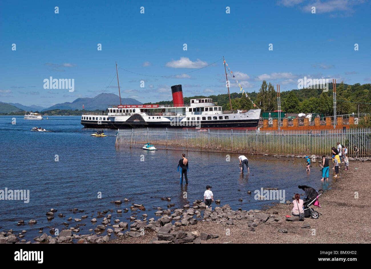paddle steamer Maid of the Loch tied up at Loch Lomond Shores in Balloch in Scotland with Ben Lomond in the background Stock Photo