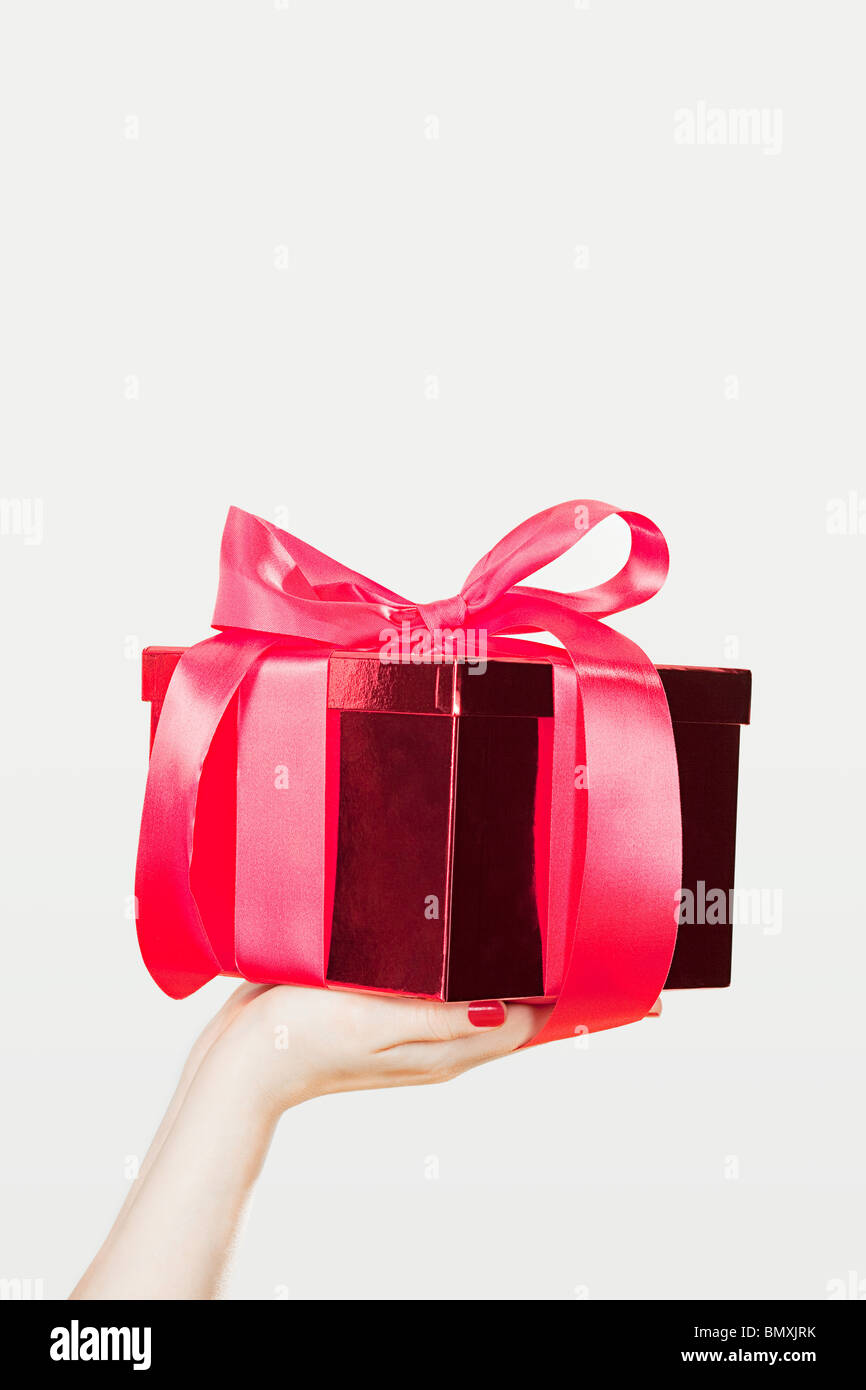 Young woman offering present Stock Photo