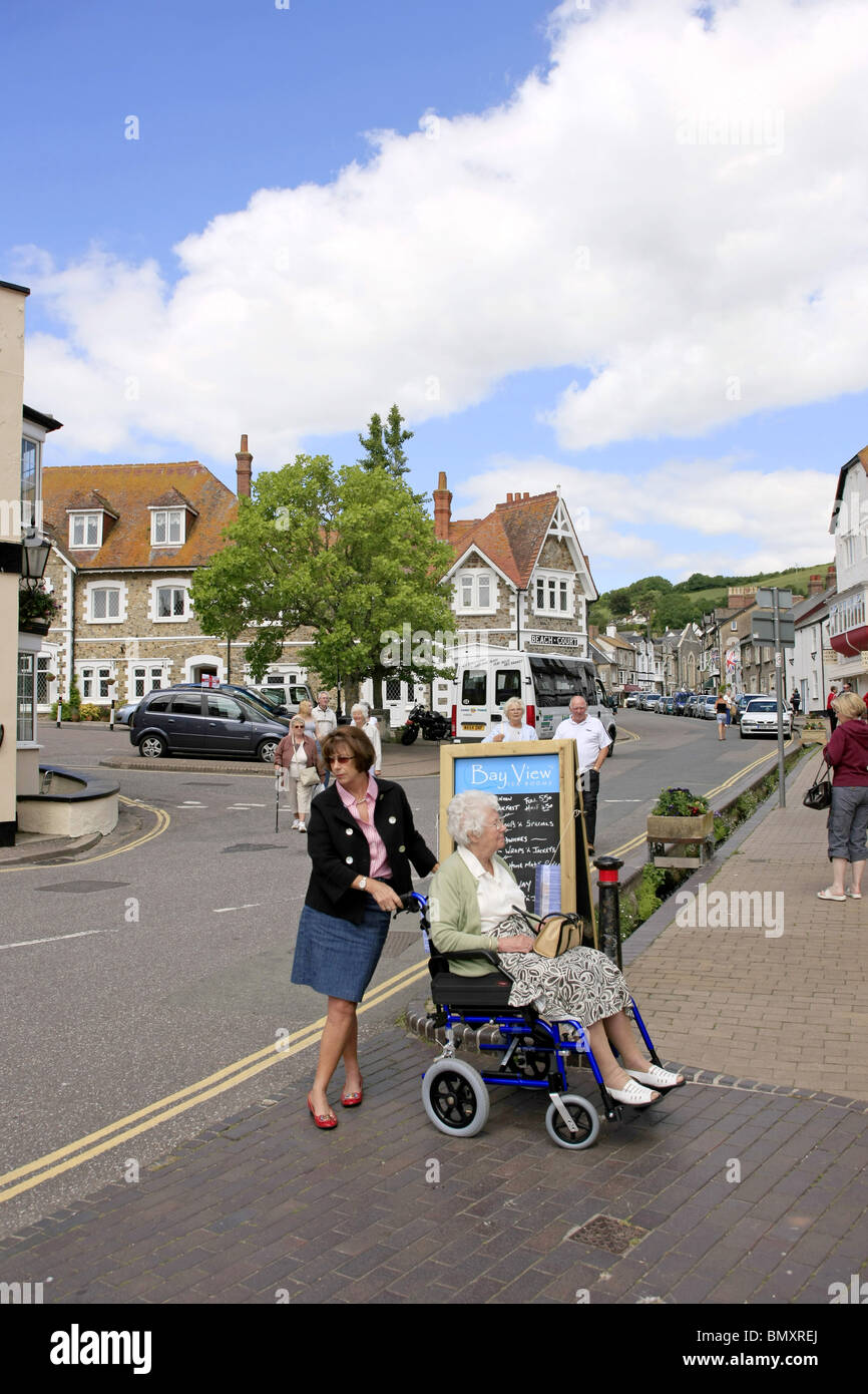 wheelchair bound woman and her cacer on a day out to Beer in Devon