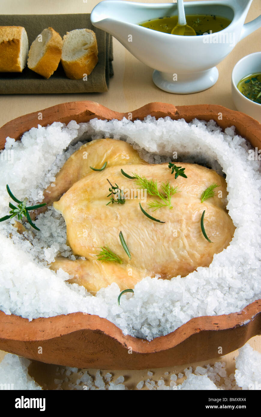 Chicken in salt crust and olive oil Stock Photo