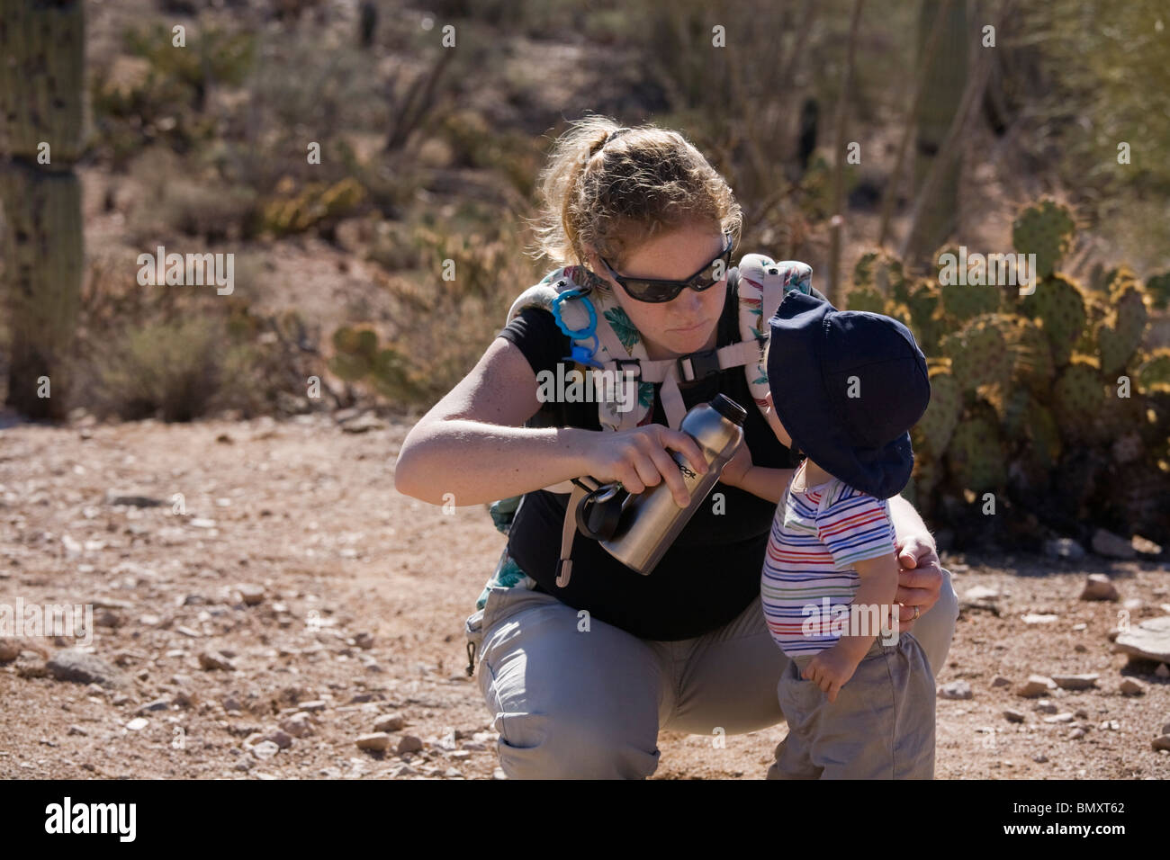 Mom giving young son drink of water at Saguaro National Park, Arizona. Stock Photo