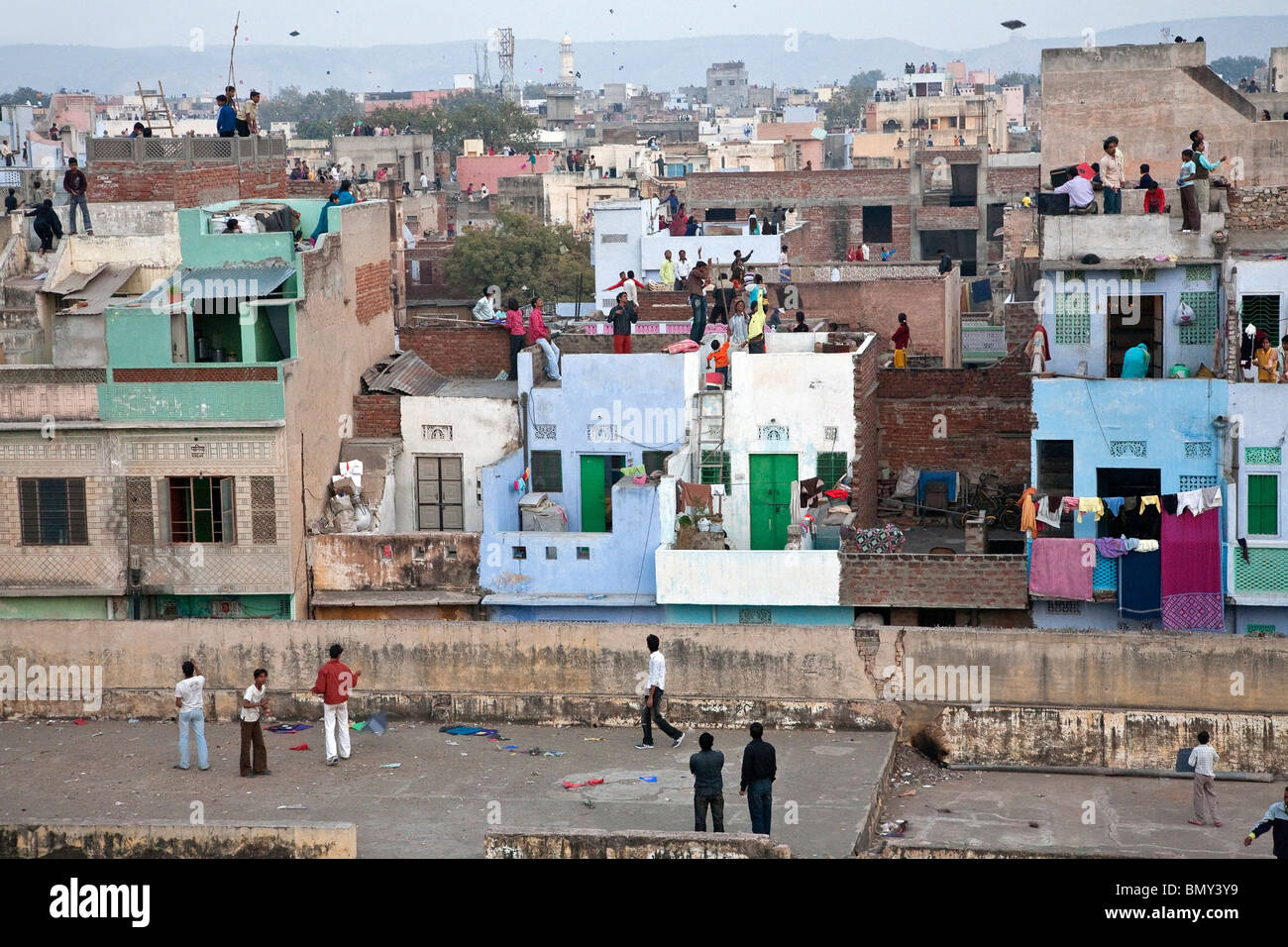 Indian people flying kites from the rooftops. Kite Day Festival. Jaipur