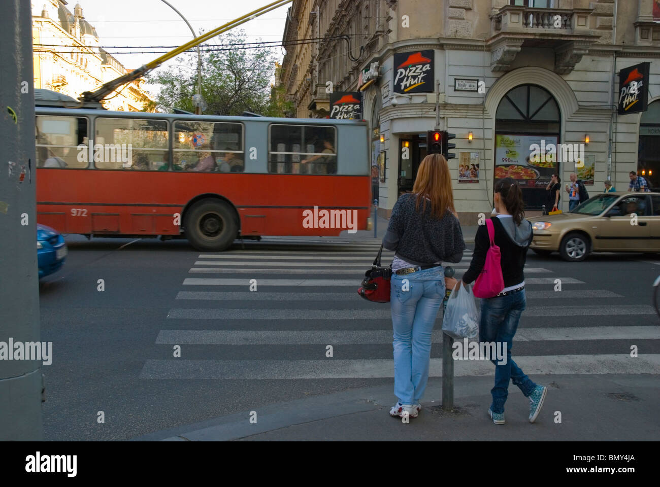 Young females waiting to cross the street central Budapest Hungary Europe Stock Photo