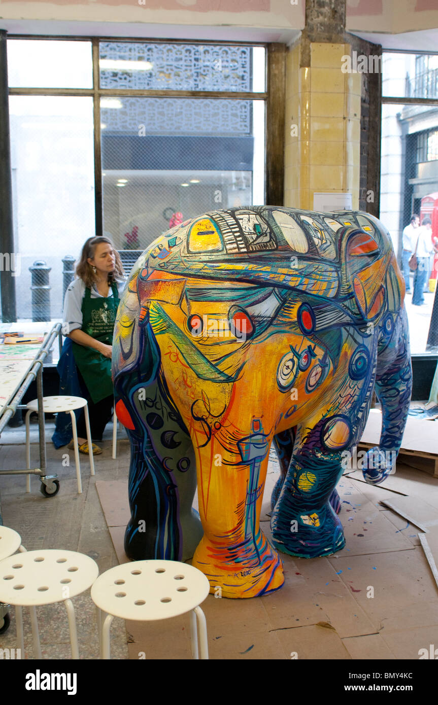 Painted elephant in Elephant Parade Gallery Store and the artist