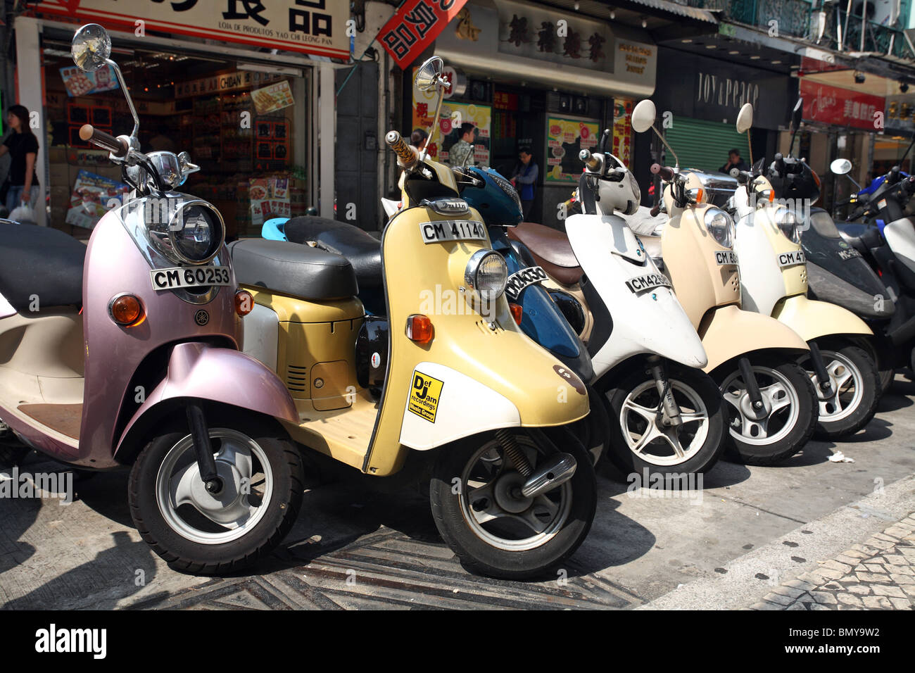 Scooters parked in a street, Macao, China Stock Photo
