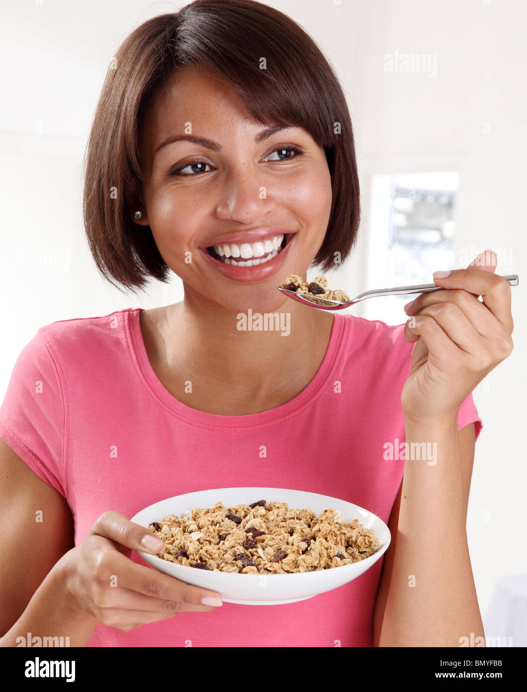 WOMAN EATING GRANOLA CEREAL Stock Photo Alamy