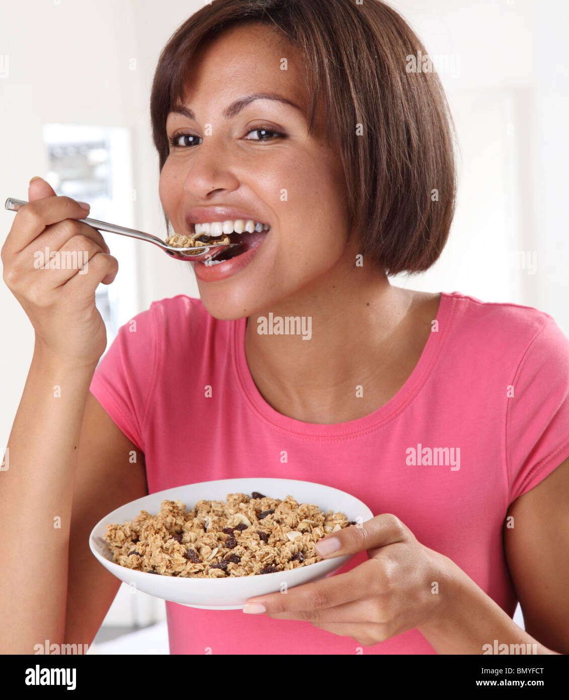 WOMAN EATING GRANOLA CEREAL Stock Photo Alamy