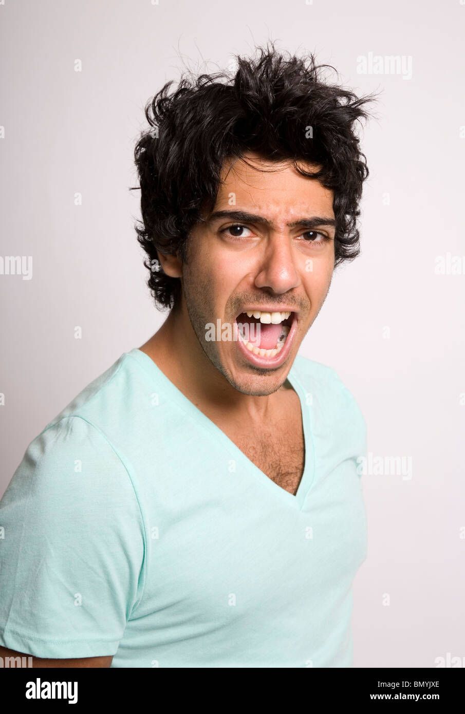 Portrait of dark haired young man shouting image