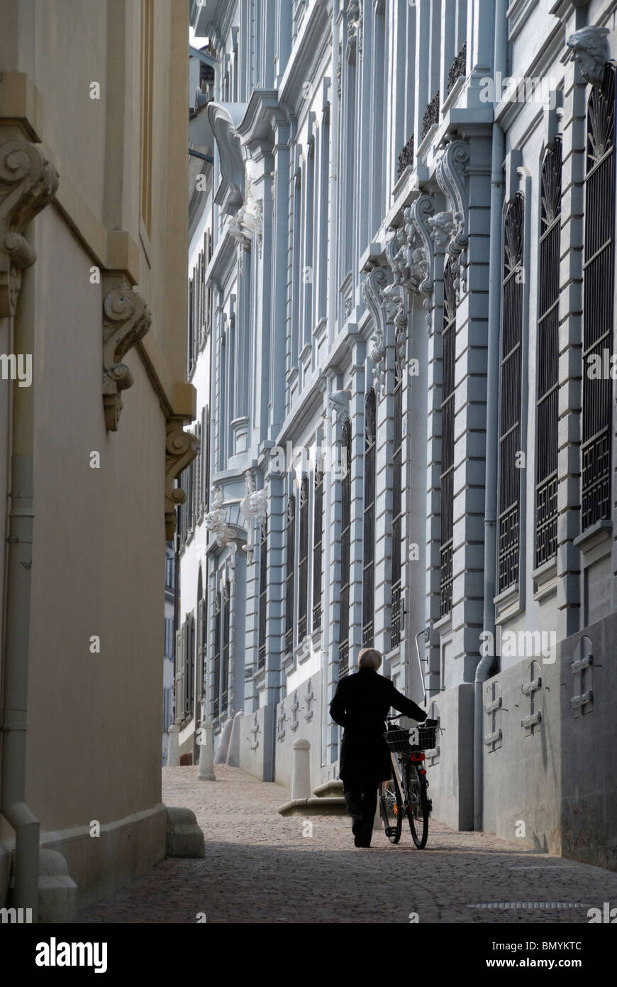 Cyclist passing the Blaues Haus in Rheinsprung, Basel, Switzerland Stock Photo
