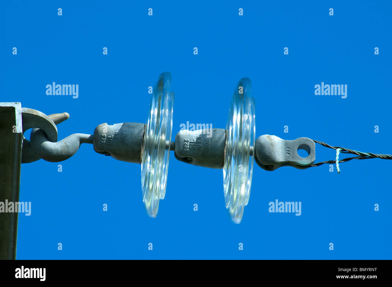 High voltage glass electrical insulators on the supporting wire of an