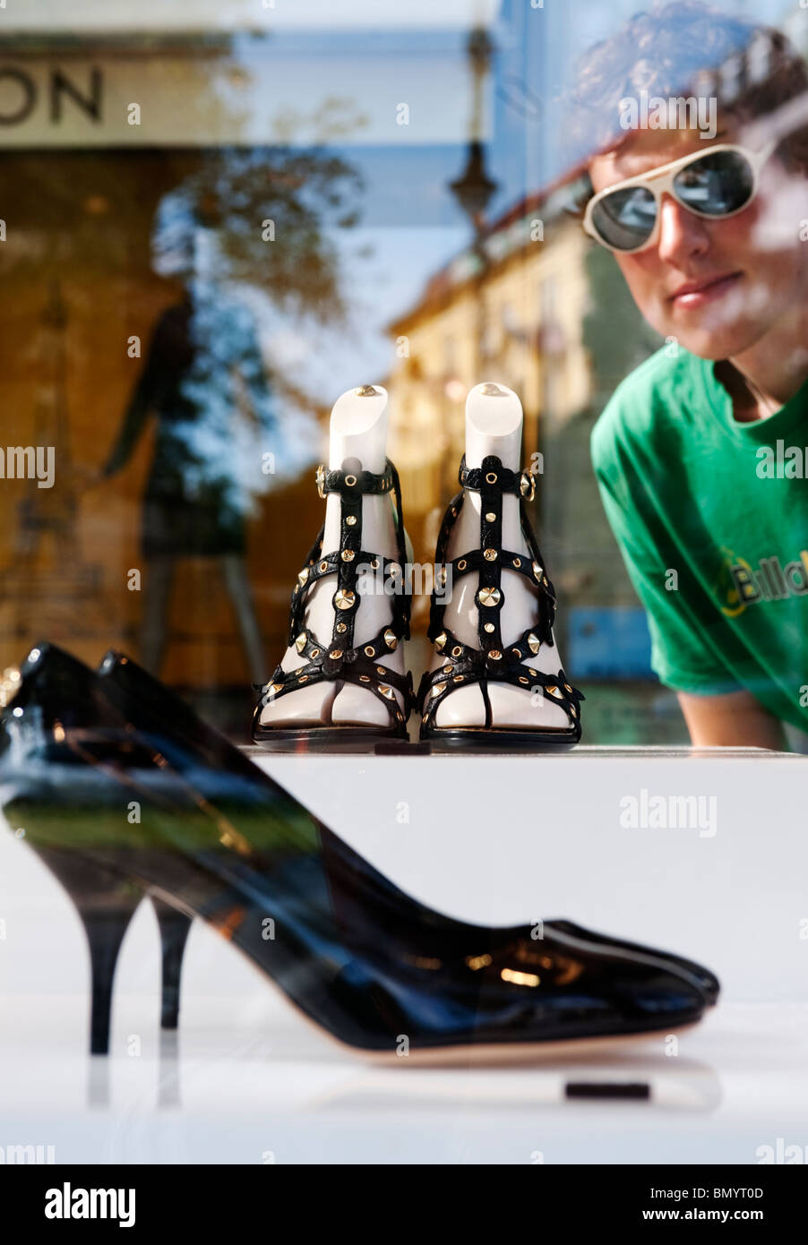 Luxury designer shoes on display in glass cabinet outside Louis