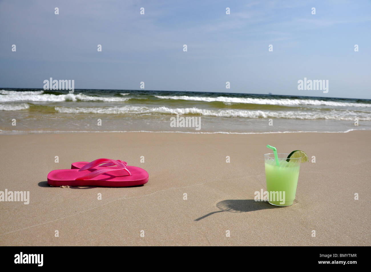 Margarita and flip flops on the beach. Stock Photo