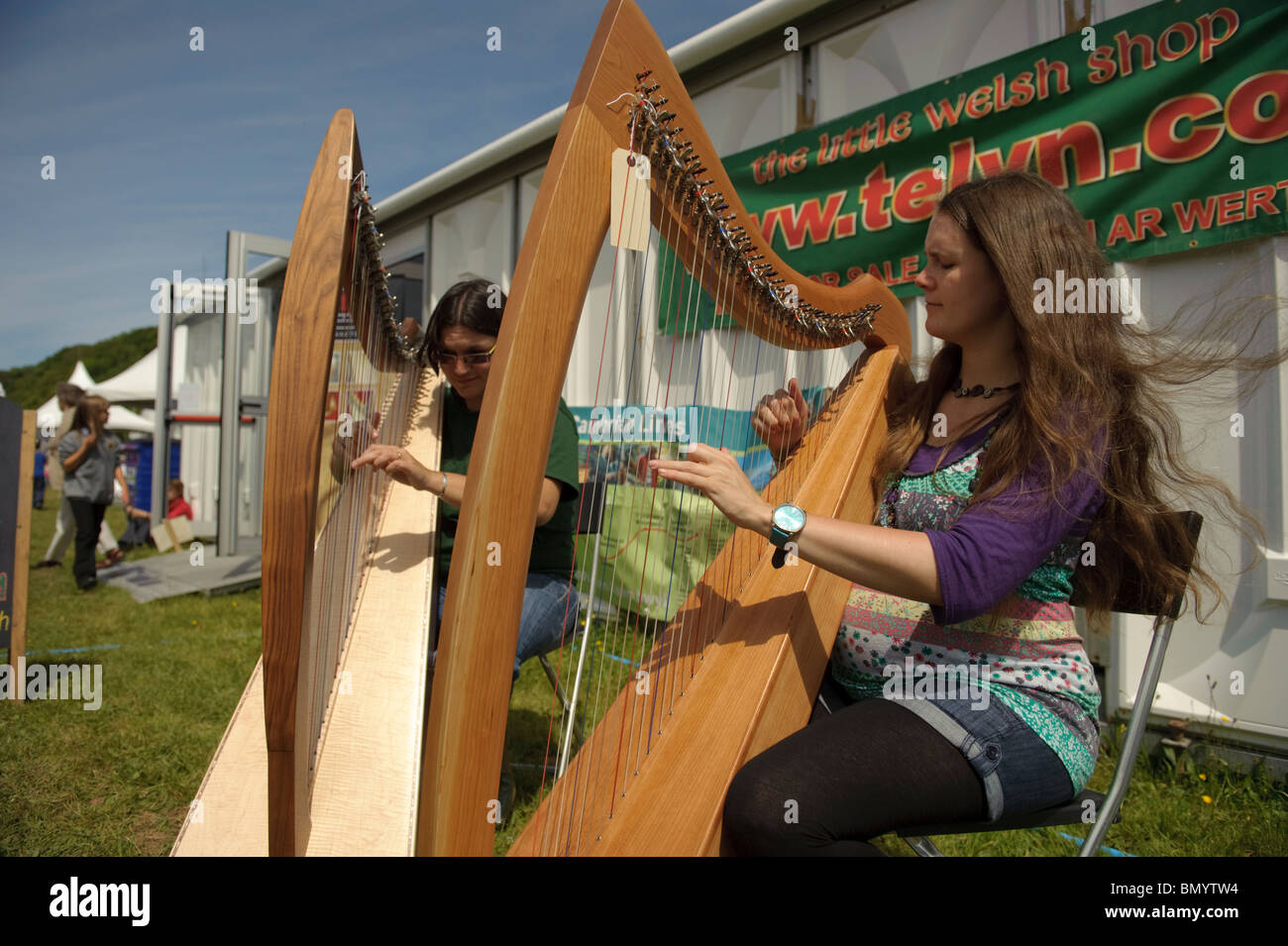 Two woman playing harps at The Urdd National Eisteddfod 2010, Llanerchaeron Ceredigion Wales UK Stock Photo