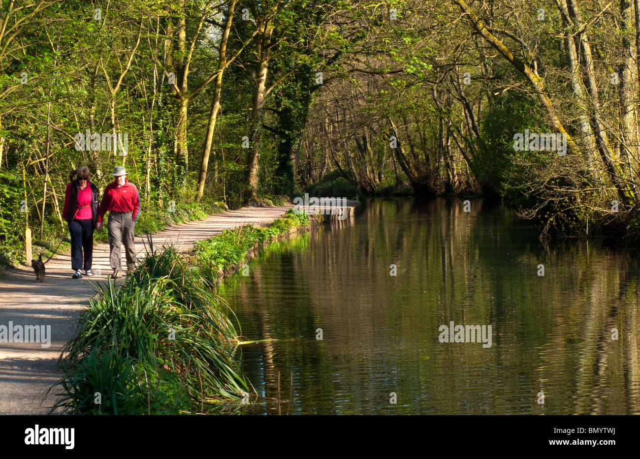 Walkers on the towpath next to Cromford Canal in the Derbyshire Dales part of the Peak District England UK Stock Photo
