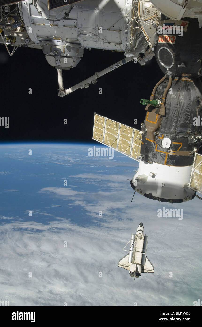 Space shuttle Endeavour, a Soyuz spacecraft, and the International Space Station. Stock Photo