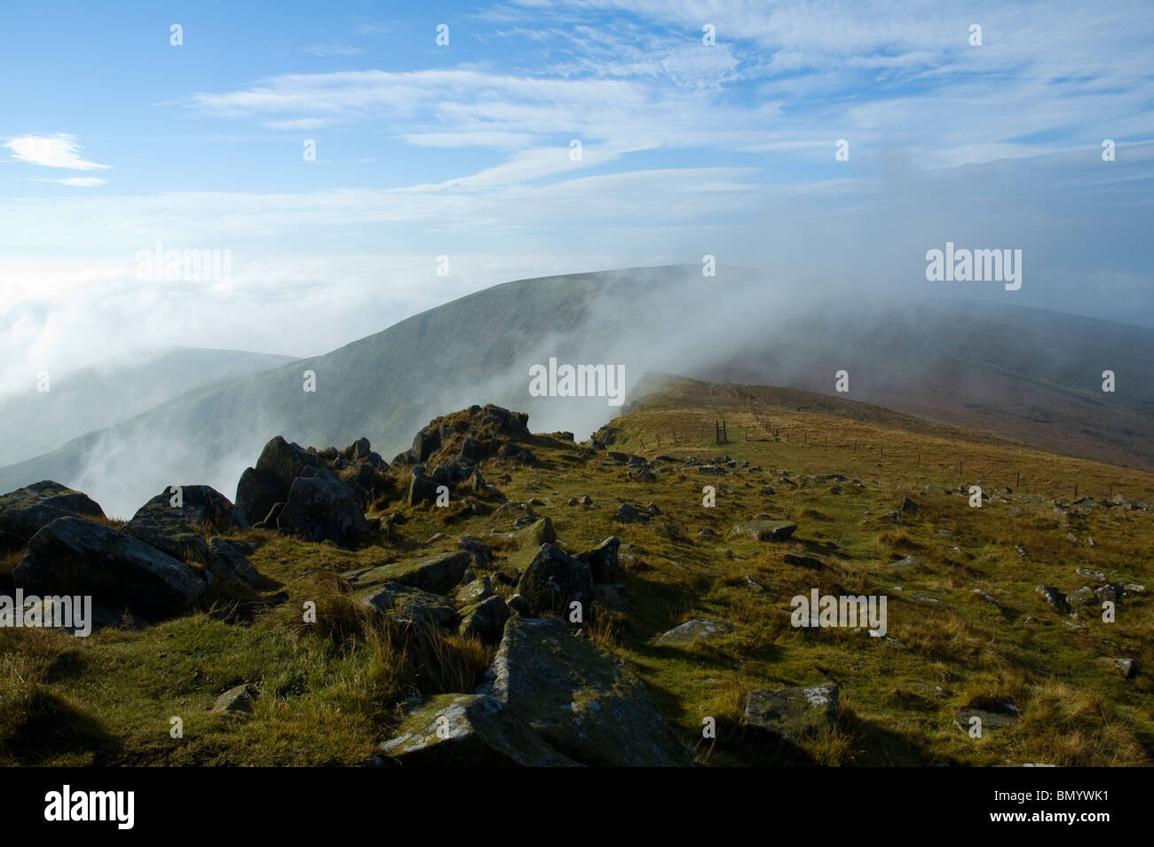 Moel Sych appears through mist and low cloud, from the summit of Cadair Berwyn, Berwyn Hills, Snowdonia, North Wales, UK Stock Photo