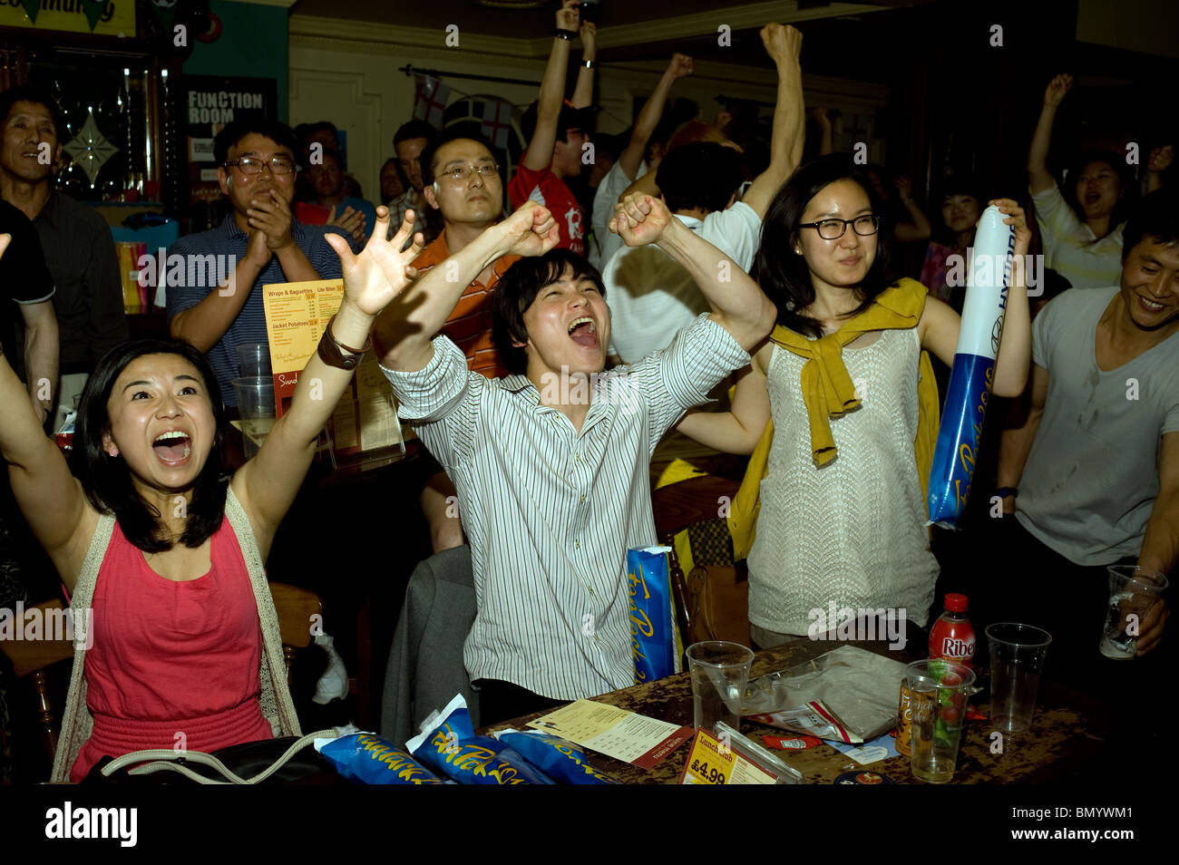 South Korean football supporters celebrating their team scoring against Nigeria in a London Pub, during the 2010 World Cup Stock Photo