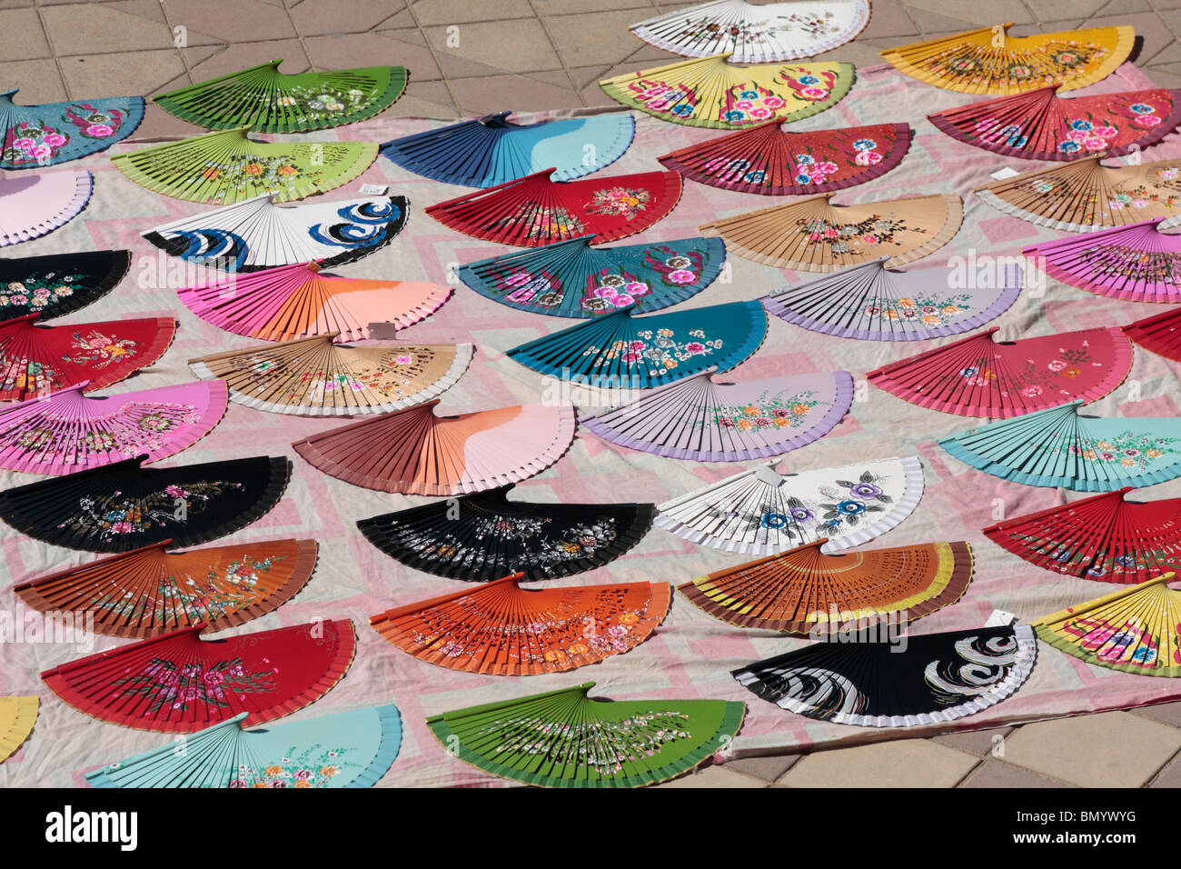 A display of painted Andalucian fans laid out for sale in the Plaza de Espana in Seville Andalucia Spain Europe Stock Photo