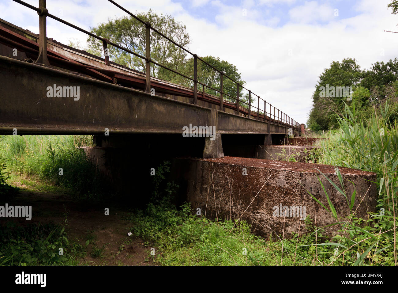 elevated railway bridge crossing countryside field Stock Photo