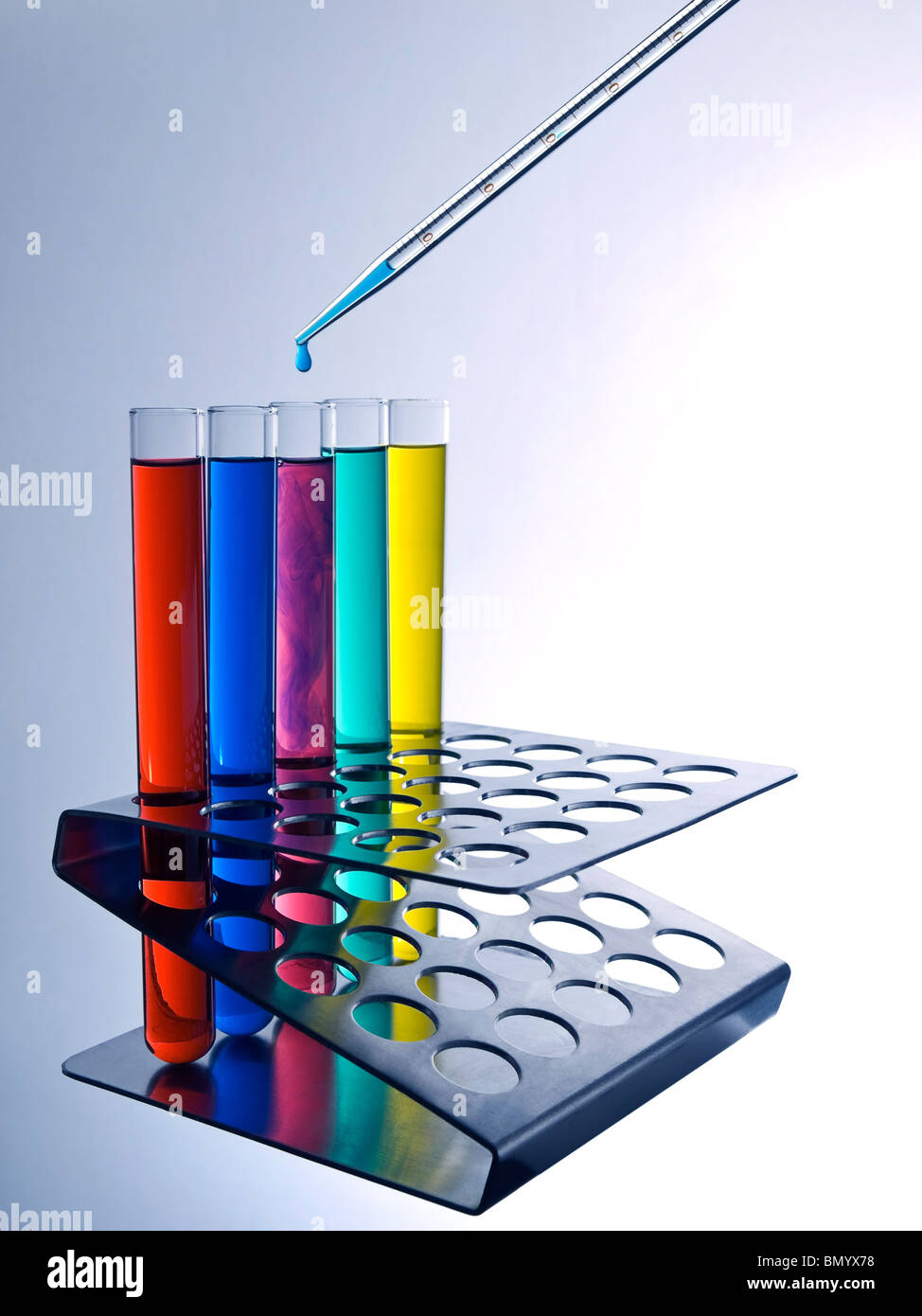 Close up of test tubes filled with color liquids and a pipette. Stock Photo