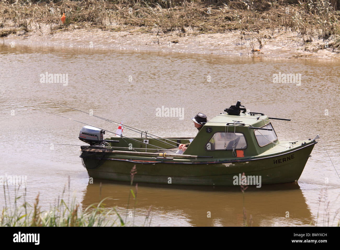 small motor fishing boat with one fisherman and many fishing rods