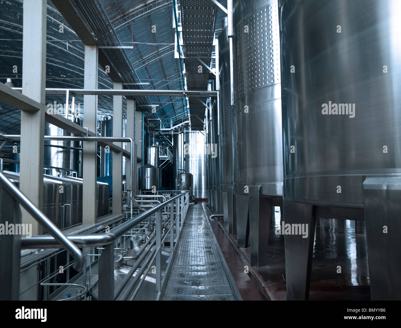 Stainless steel wine vats in a row inside the winery. Stock Photo