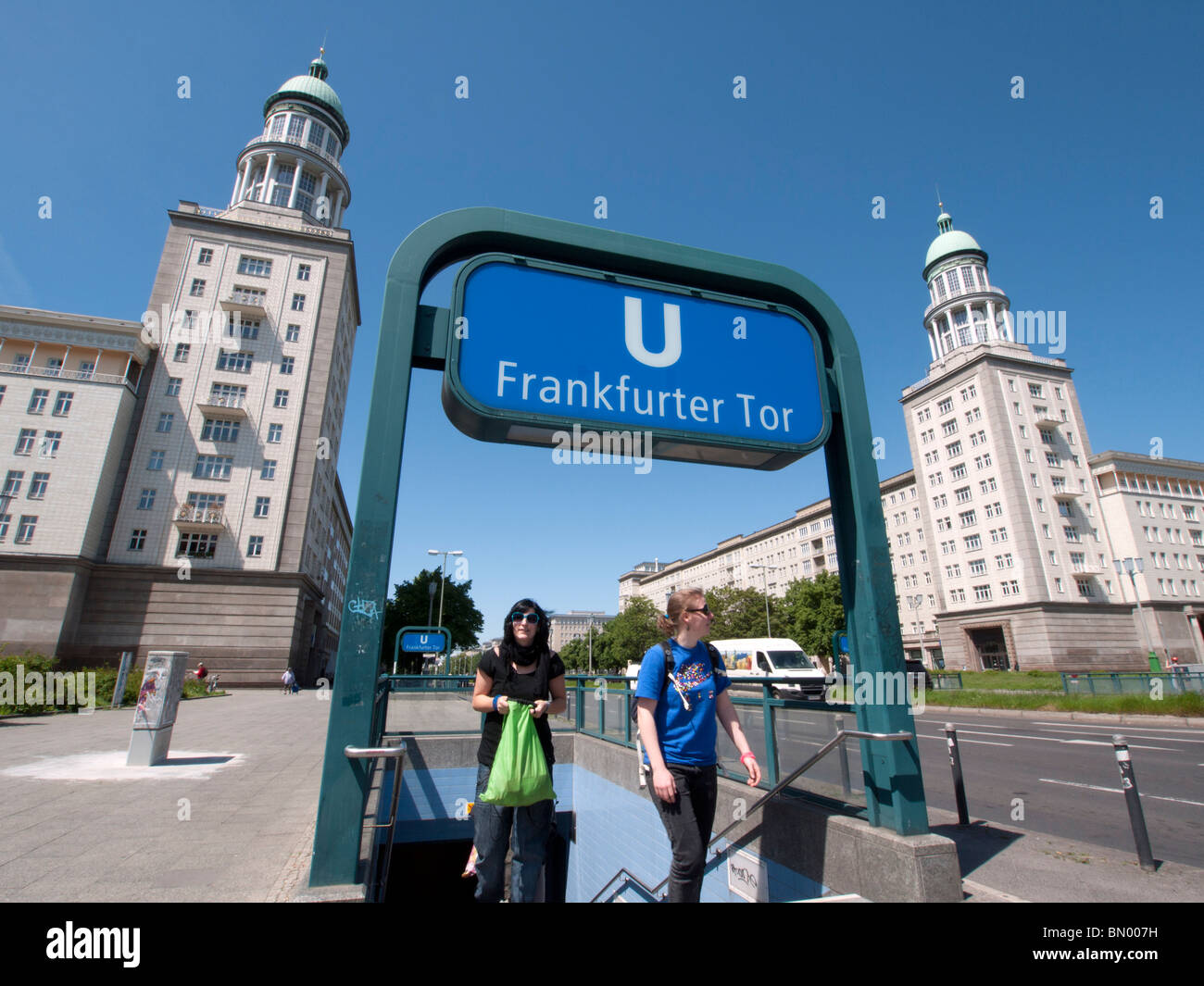 Underground station exit in front of famous East German era Frankfurter Tor buildings with towers on Karl Marx Allee in Berlin G Stock Photo