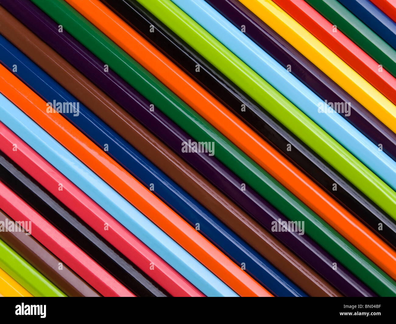 Top view of assorted color pencils disposed one next to the other. Stock Photo