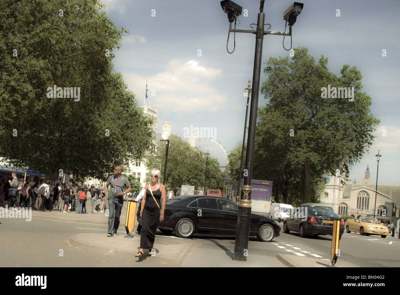 Crossroad with the people crossing, Westminster Abbey and London Eye in the background Stock Photo