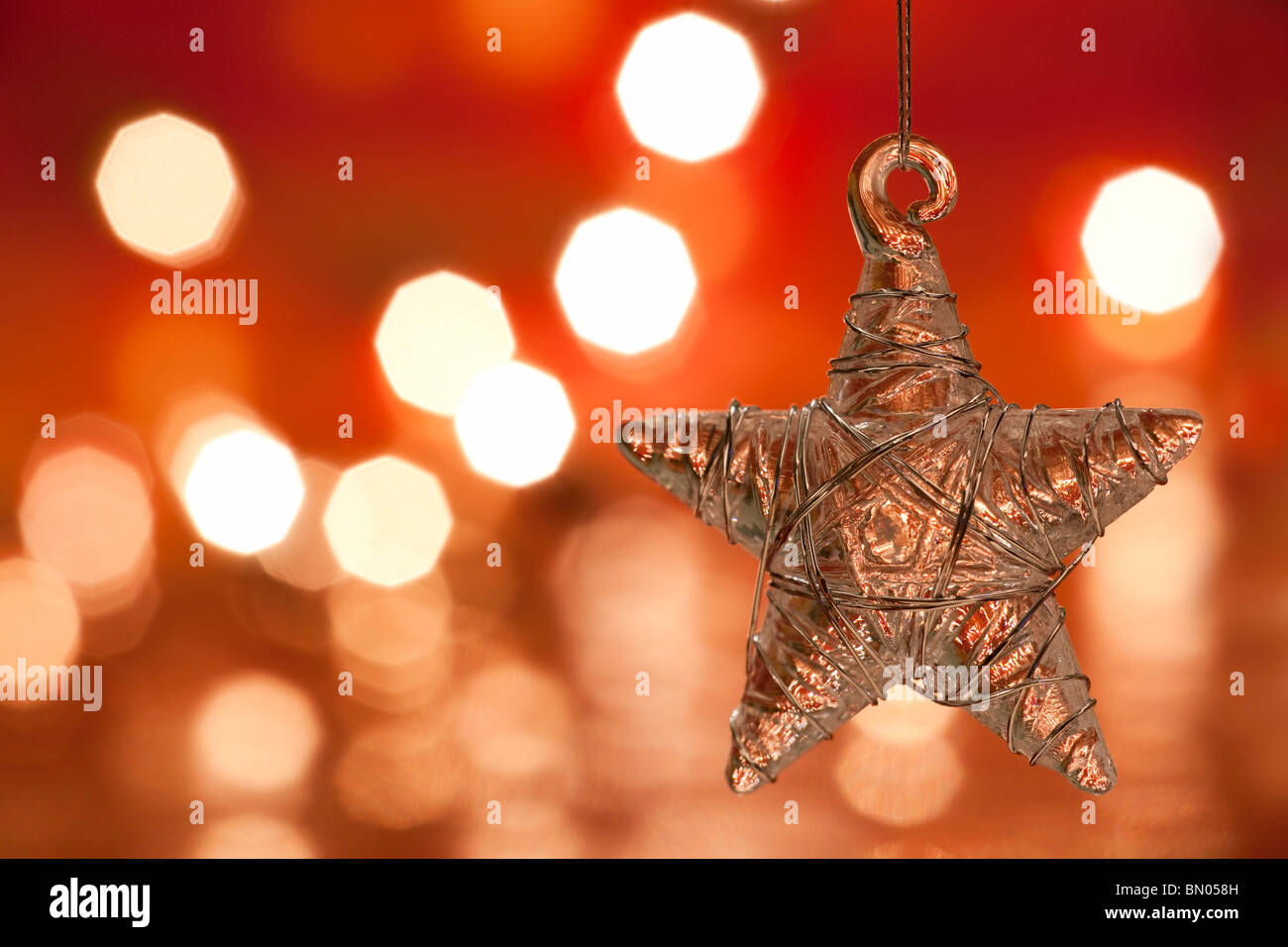 Christmas decoration - glass star. Blurred lights background. aRGB. Stock Photo