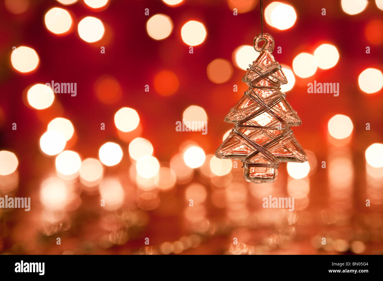 Christmas decoration - glass christmas tree. Blurred lights background. aRGB. Stock Photo