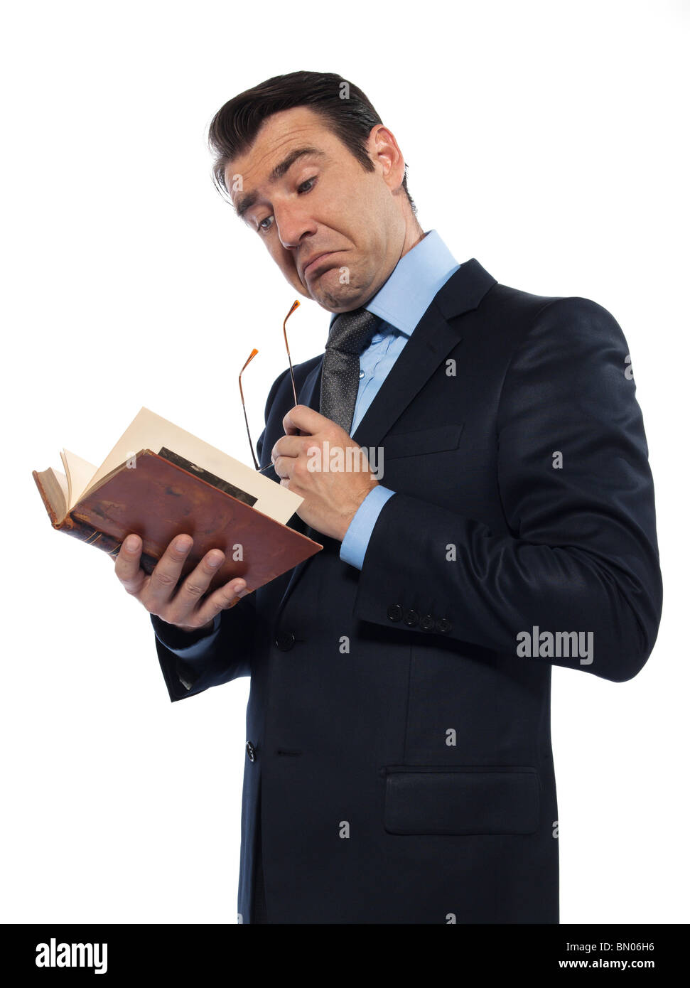 man caucasian teacher professor reading holding ancient book thinking isolated studio on white background Stock Photo