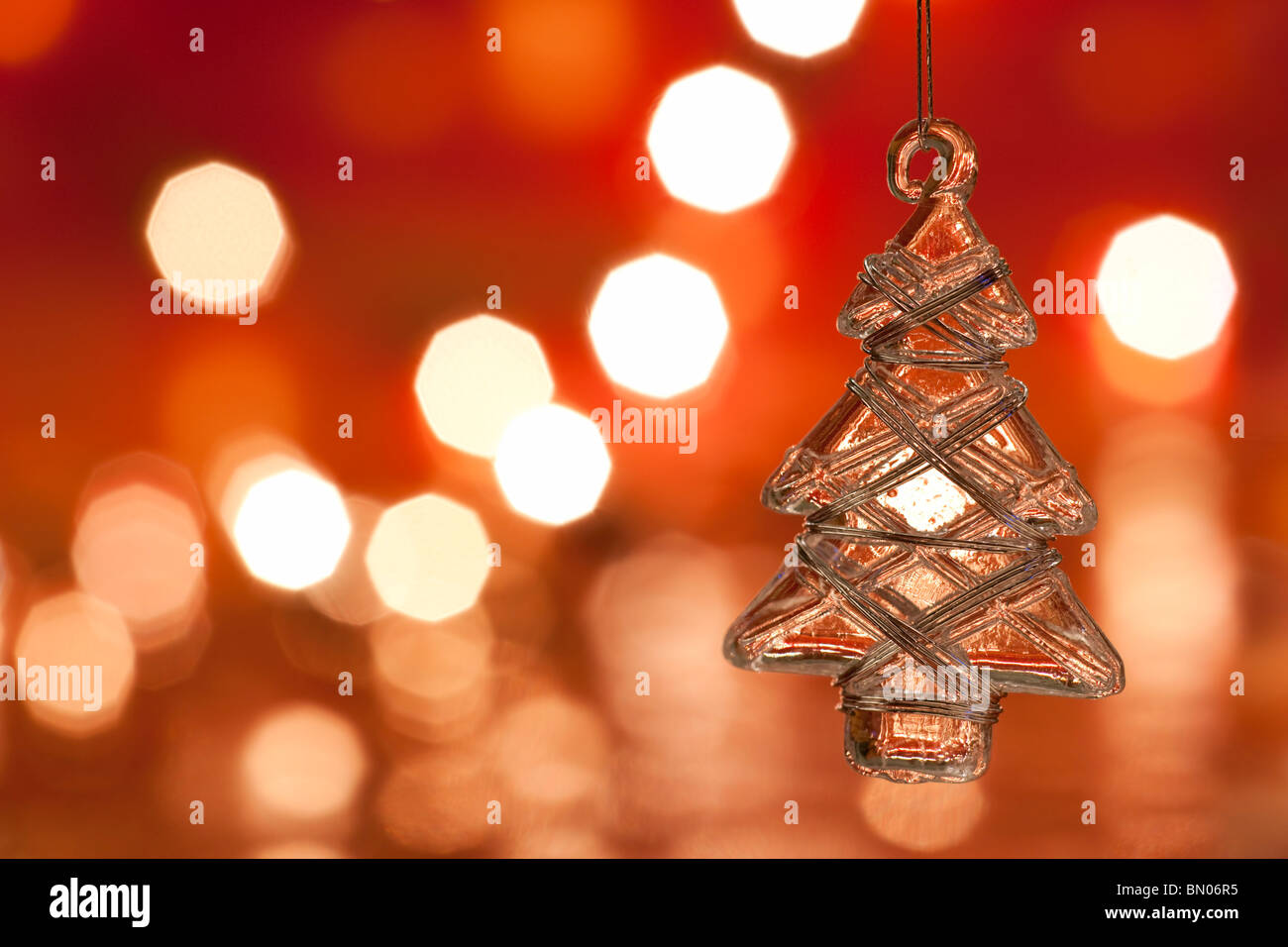 Christmas decoration - glass christmas tree. Blurred lights background. aRGB. Stock Photo
