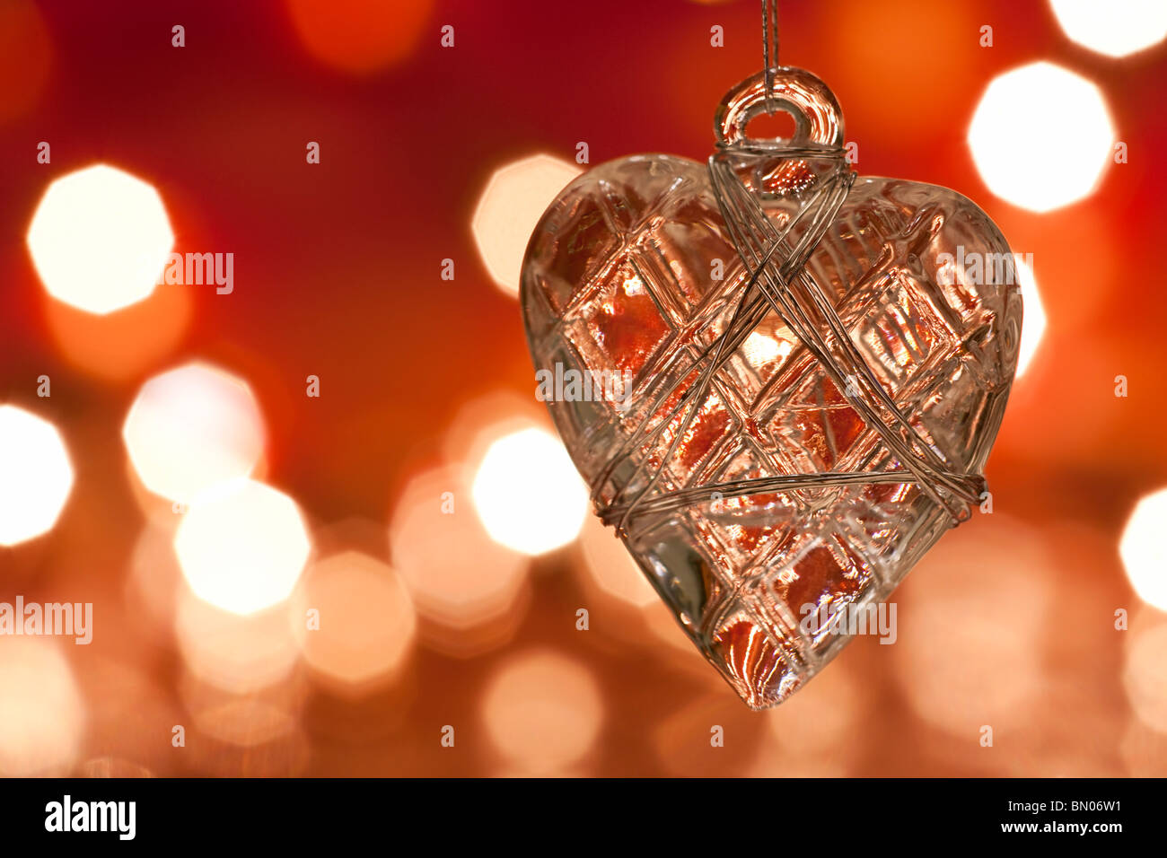 Christmas decoration - glass heart. Blurred lights background. aRGB. Stock Photo